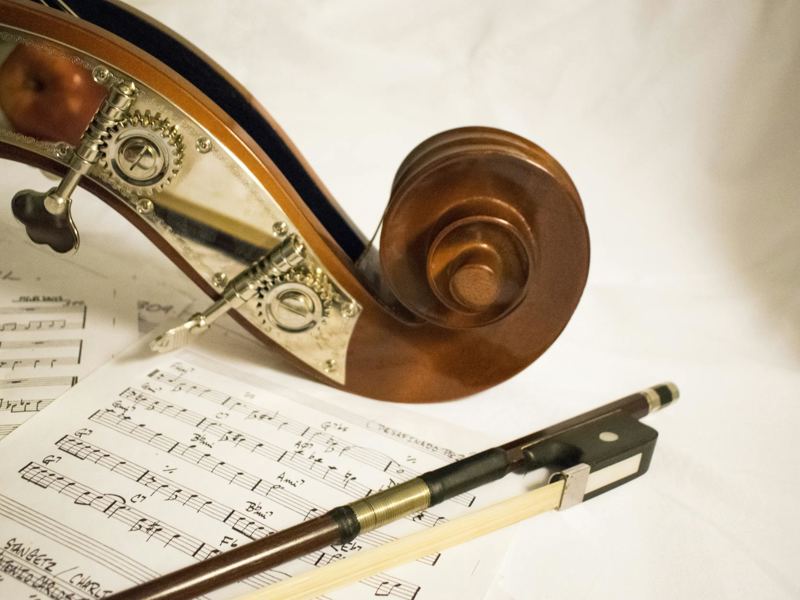 capture of a bass scroll and bow on sheet music, highlighting musical image
