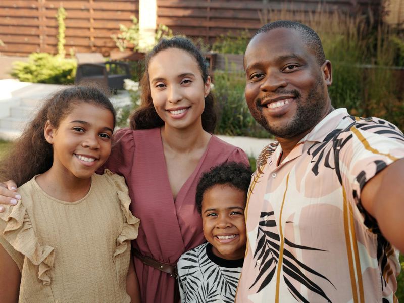 smiling multicultural family enjoying time together outdoors in their image